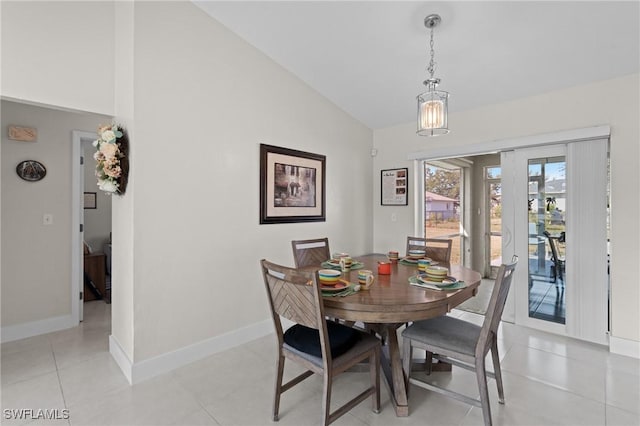 tiled dining room featuring lofted ceiling