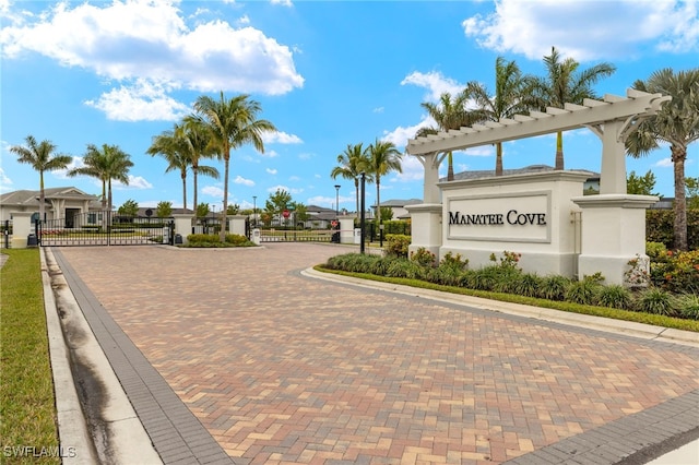 view of home's community featuring a gate and fence