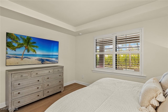 bedroom with baseboards and wood finished floors