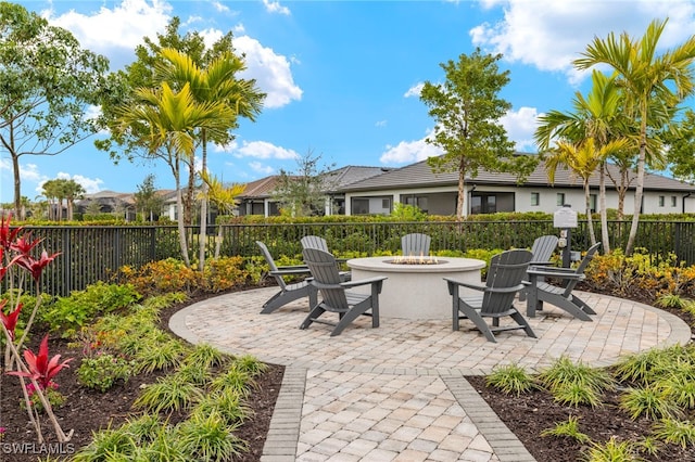 view of patio featuring fence and a fire pit