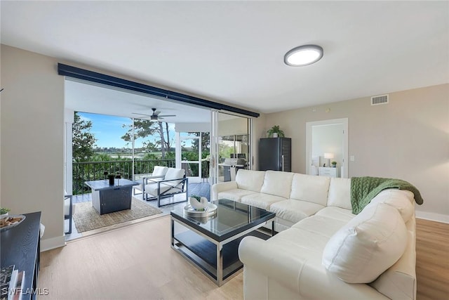 living room with hardwood / wood-style flooring and ceiling fan