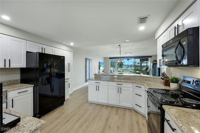 kitchen featuring white cabinetry, pendant lighting, kitchen peninsula, and black appliances