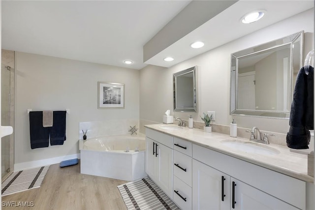 bathroom featuring vanity, a tub, and hardwood / wood-style flooring