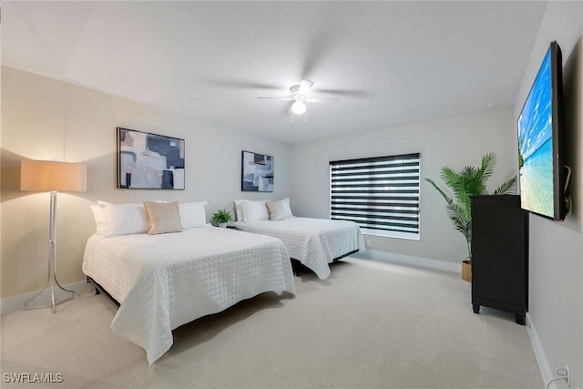 bedroom with ceiling fan and light carpet