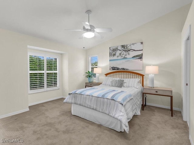 bedroom with vaulted ceiling, light carpet, and ceiling fan