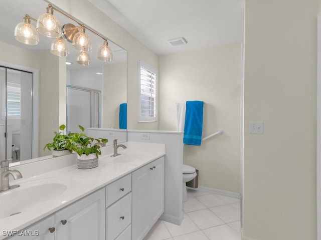 bathroom with tile patterned floors, vanity, toilet, and a shower with shower door