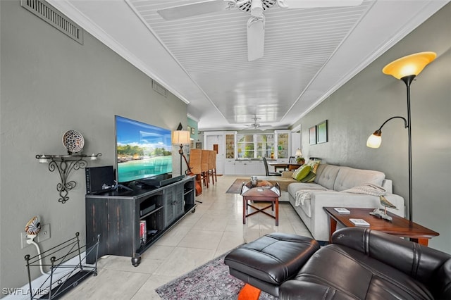 living room with ceiling fan, light tile patterned flooring, and crown molding