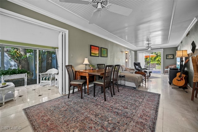 dining area with ceiling fan, ornamental molding, and light tile patterned flooring