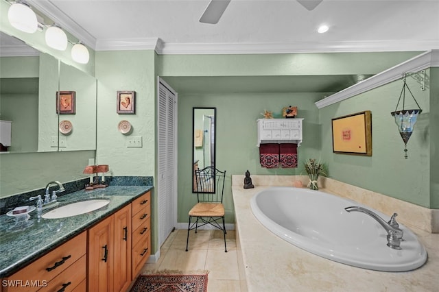 bathroom with a washtub, tile patterned floors, vanity, and ornamental molding