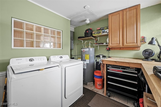 washroom with washer and dryer, cabinets, and water heater