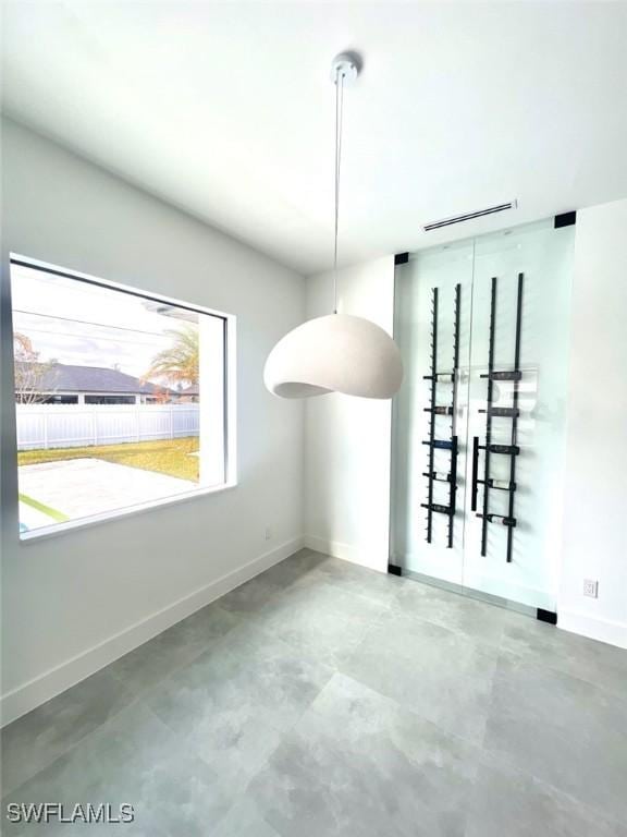 unfurnished dining area featuring concrete flooring