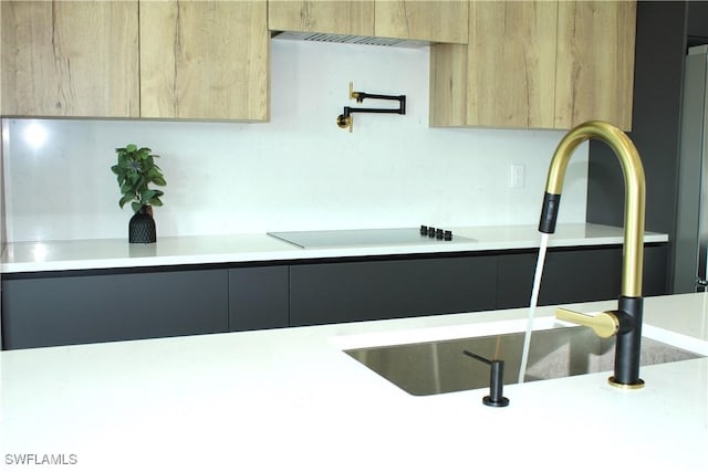 kitchen featuring sink, light brown cabinets, and black electric cooktop