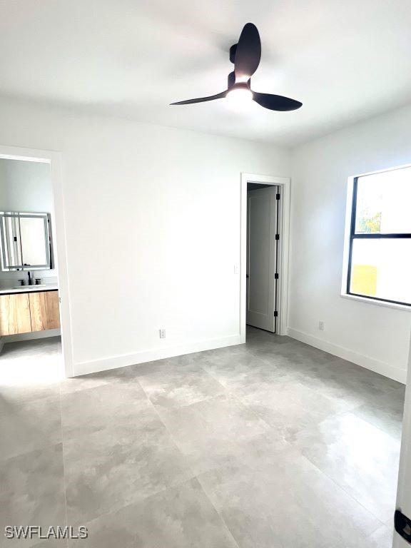 empty room featuring ceiling fan and sink