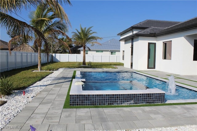 view of swimming pool with pool water feature and a patio