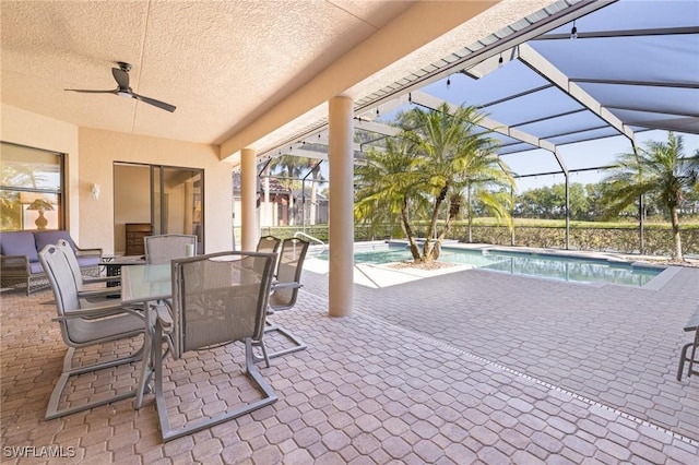 9284 Trieste Dr, Fort Myers, FL 33913 - view of patio with glass enclosure, outdoor dining area, a ceiling fan, and an outdoor pool