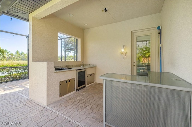 9284 Trieste Dr, Fort Myers, FL 33913 - view of patio with exterior kitchen, a lanai, and beverage cooler