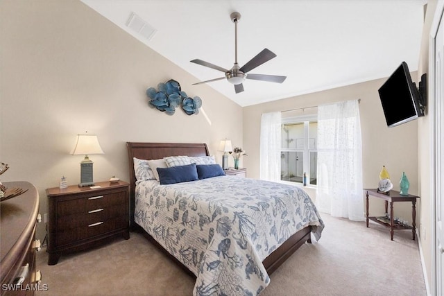 carpeted bedroom featuring ceiling fan and vaulted ceiling