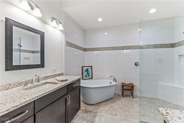 bathroom featuring separate shower and tub, tile patterned floors, and vanity