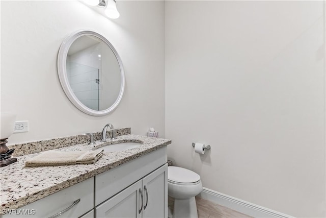 bathroom featuring tile patterned floors, vanity, and toilet