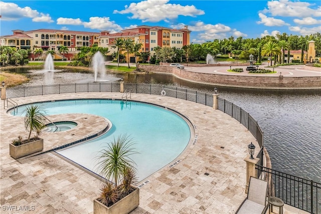 view of swimming pool featuring a water view