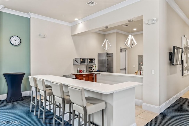 kitchen featuring stainless steel appliances, a kitchen breakfast bar, kitchen peninsula, light tile patterned flooring, and ornamental molding