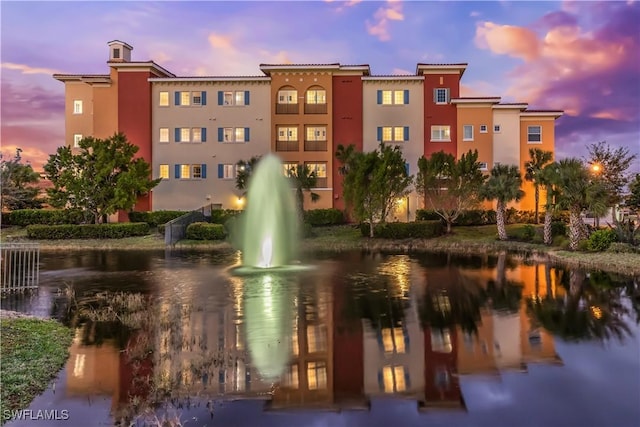 outdoor building at dusk featuring a water view