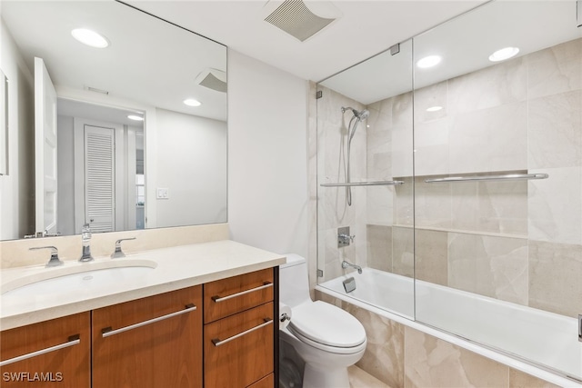 bathroom with toilet, recessed lighting, tiled shower / bath combo, vanity, and visible vents