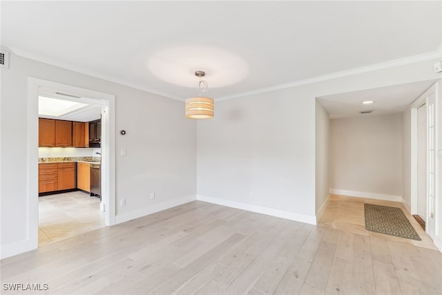 interior space with ornamental molding, light wood-type flooring, and baseboards