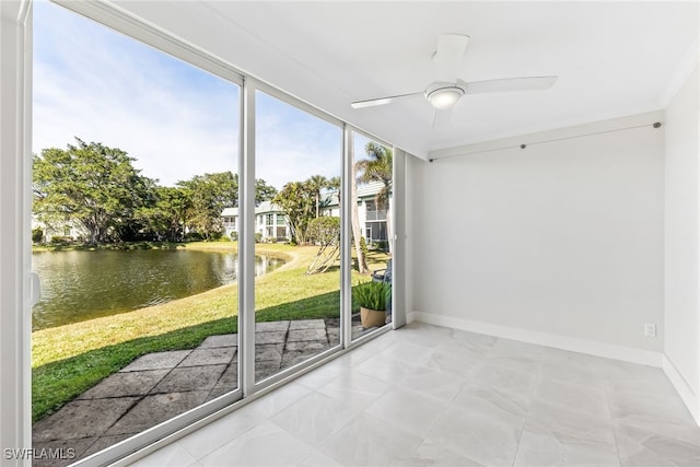 unfurnished sunroom featuring a ceiling fan and a water view