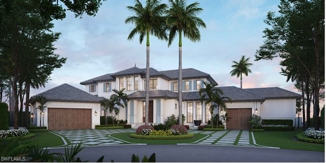 view of front facade featuring a garage and a yard