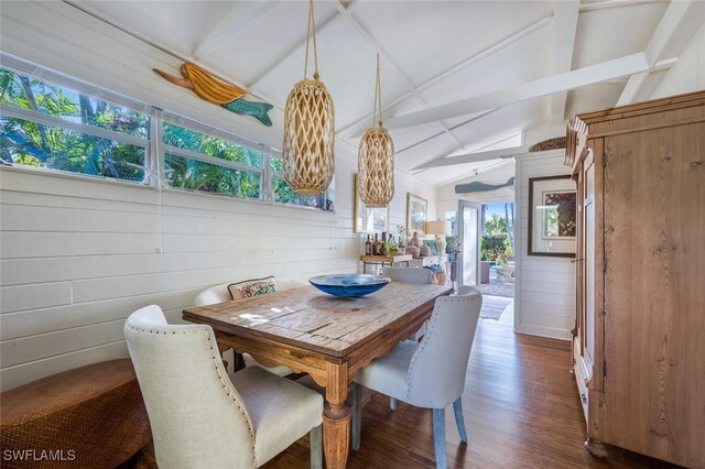 dining room featuring vaulted ceiling and dark hardwood / wood-style flooring