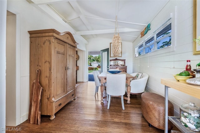 dining room featuring beam ceiling and dark hardwood / wood-style flooring