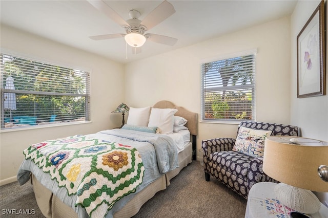 carpeted bedroom featuring ceiling fan and multiple windows