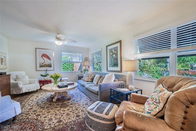 living room featuring ceiling fan and a wealth of natural light