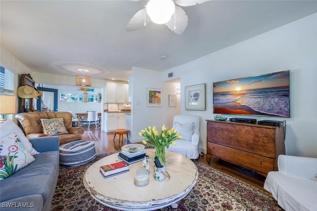 living room with ceiling fan and hardwood / wood-style floors