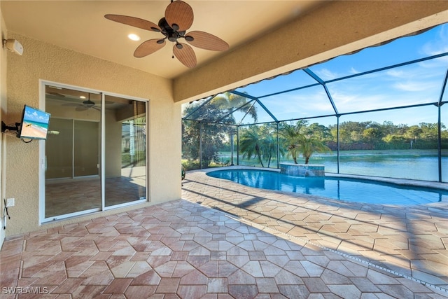 view of pool with a water view, ceiling fan, a patio area, and glass enclosure