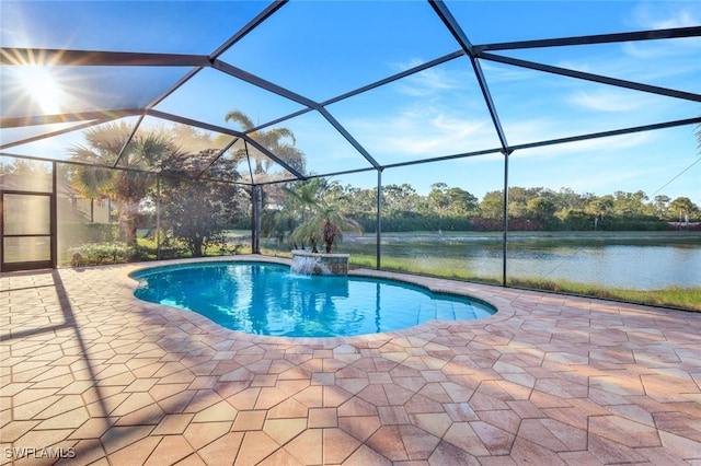 view of pool with a patio area, a lanai, pool water feature, and a water view