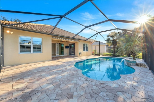 view of pool with a lanai, ceiling fan, and a patio area