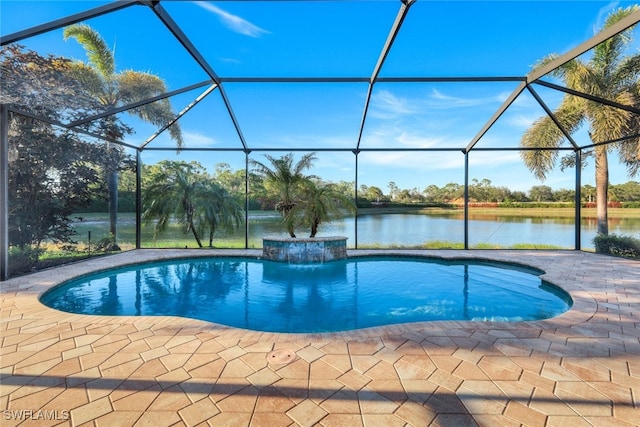 view of pool featuring glass enclosure, a water view, and a patio