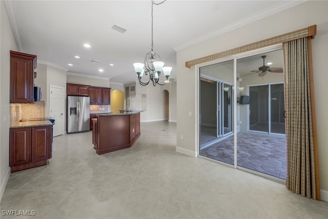 kitchen with stainless steel refrigerator with ice dispenser, tasteful backsplash, pendant lighting, ceiling fan with notable chandelier, and a center island