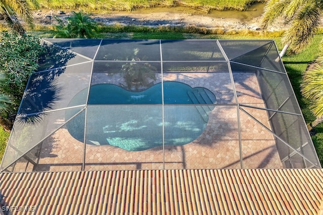 view of pool featuring a patio and glass enclosure