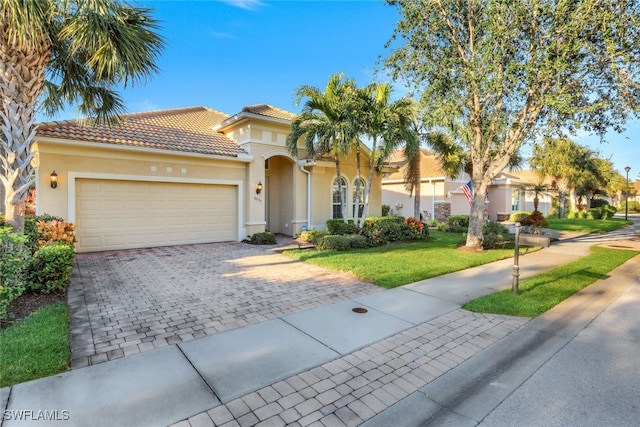 mediterranean / spanish house featuring a garage and a front lawn