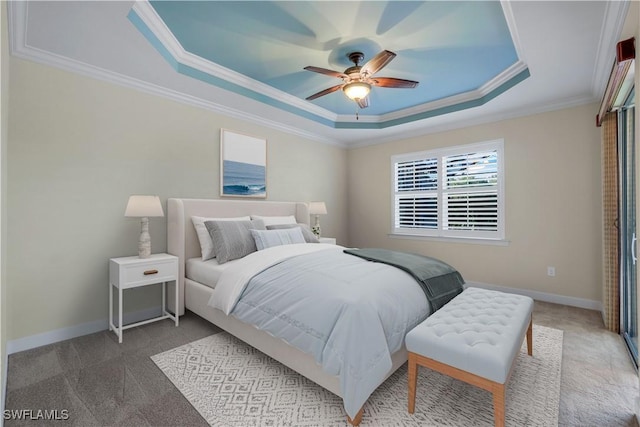 bedroom featuring a raised ceiling, ceiling fan, carpet, and crown molding