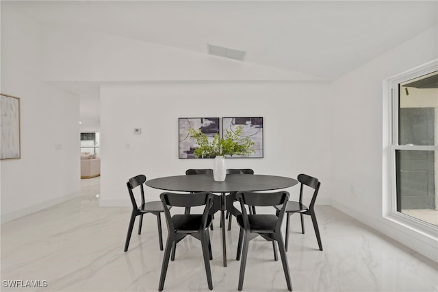 dining space with vaulted ceiling