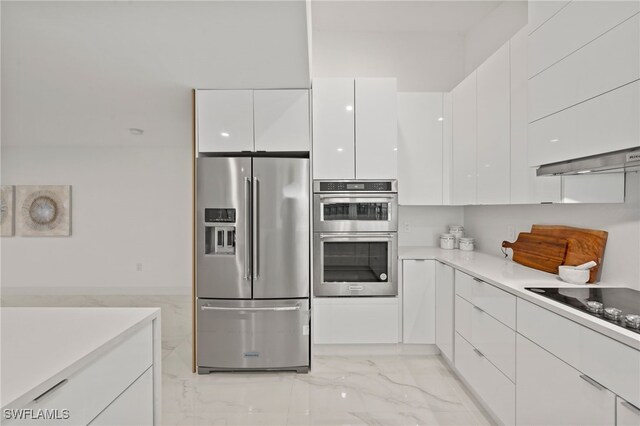 kitchen with white cabinetry, appliances with stainless steel finishes, and range hood