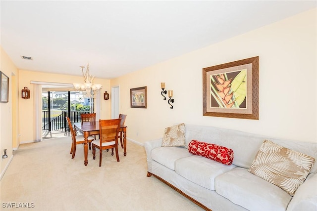 carpeted dining space with a notable chandelier