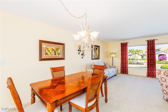 carpeted dining room with a chandelier