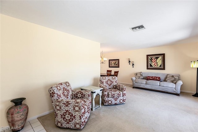 carpeted living room featuring a notable chandelier