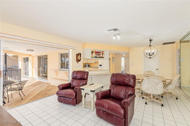 living room with light tile patterned flooring and a chandelier