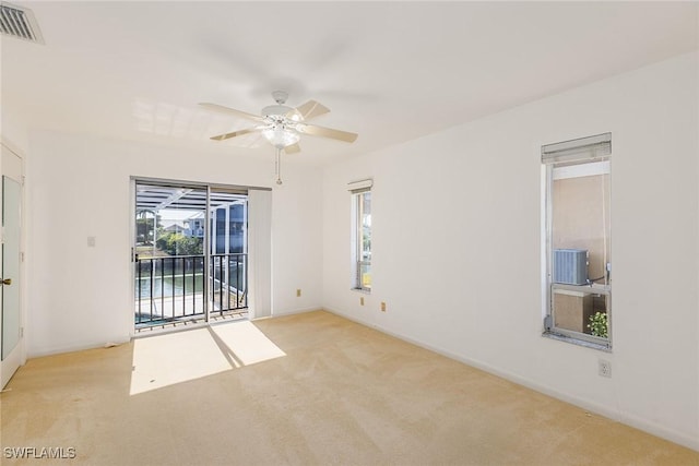 carpeted spare room with ceiling fan